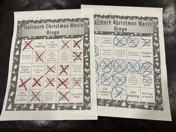 Two printed bingo cards for Hallmark Christmas movies